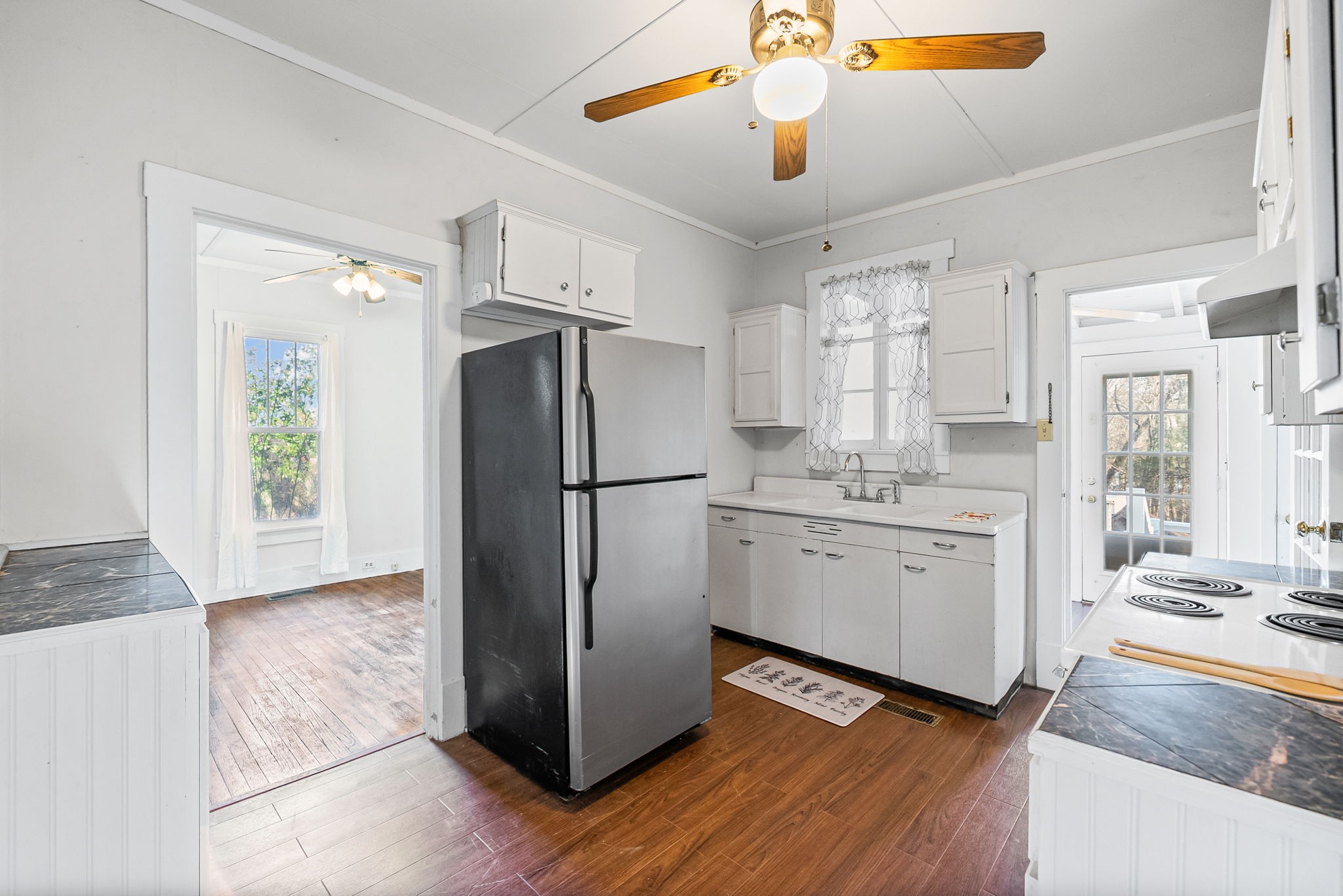 106 Cedar Street Dover, TN 37058 - Photo 7 of 32 a kitchen with a refrigerator a sink and cabinets