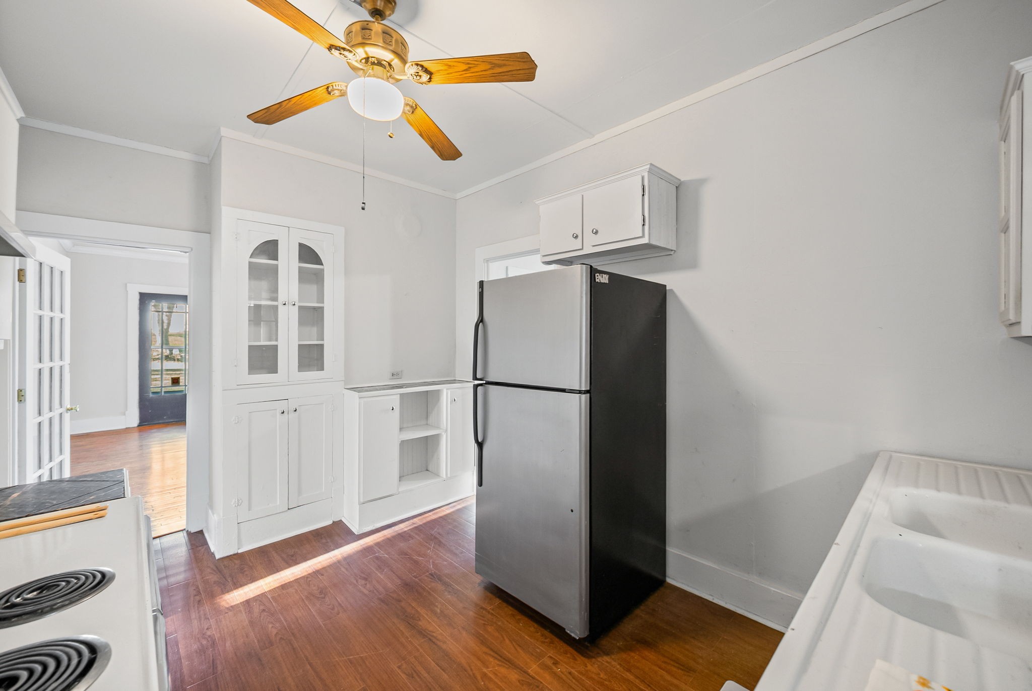 106 Cedar Street Dover, TN 37058 - Photo 8 of 32 a view of a kitchen with a refrigerator a ceiling fan and wooden floor
