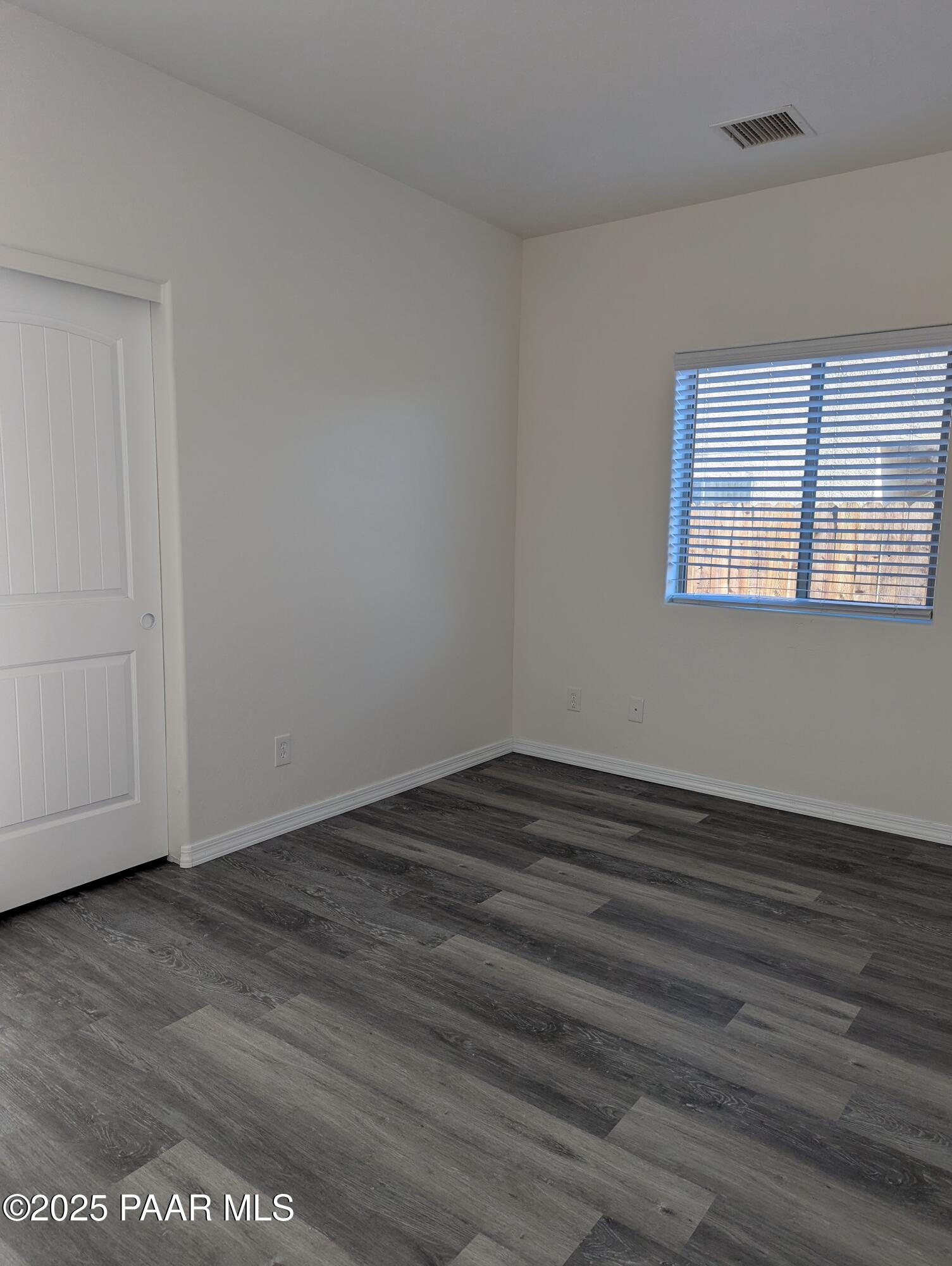 2976 North Yavapai Road East, Unit 2 Prescott Valley, AZ 86314 - Photo 9 of 12 wooden floor in an empty room