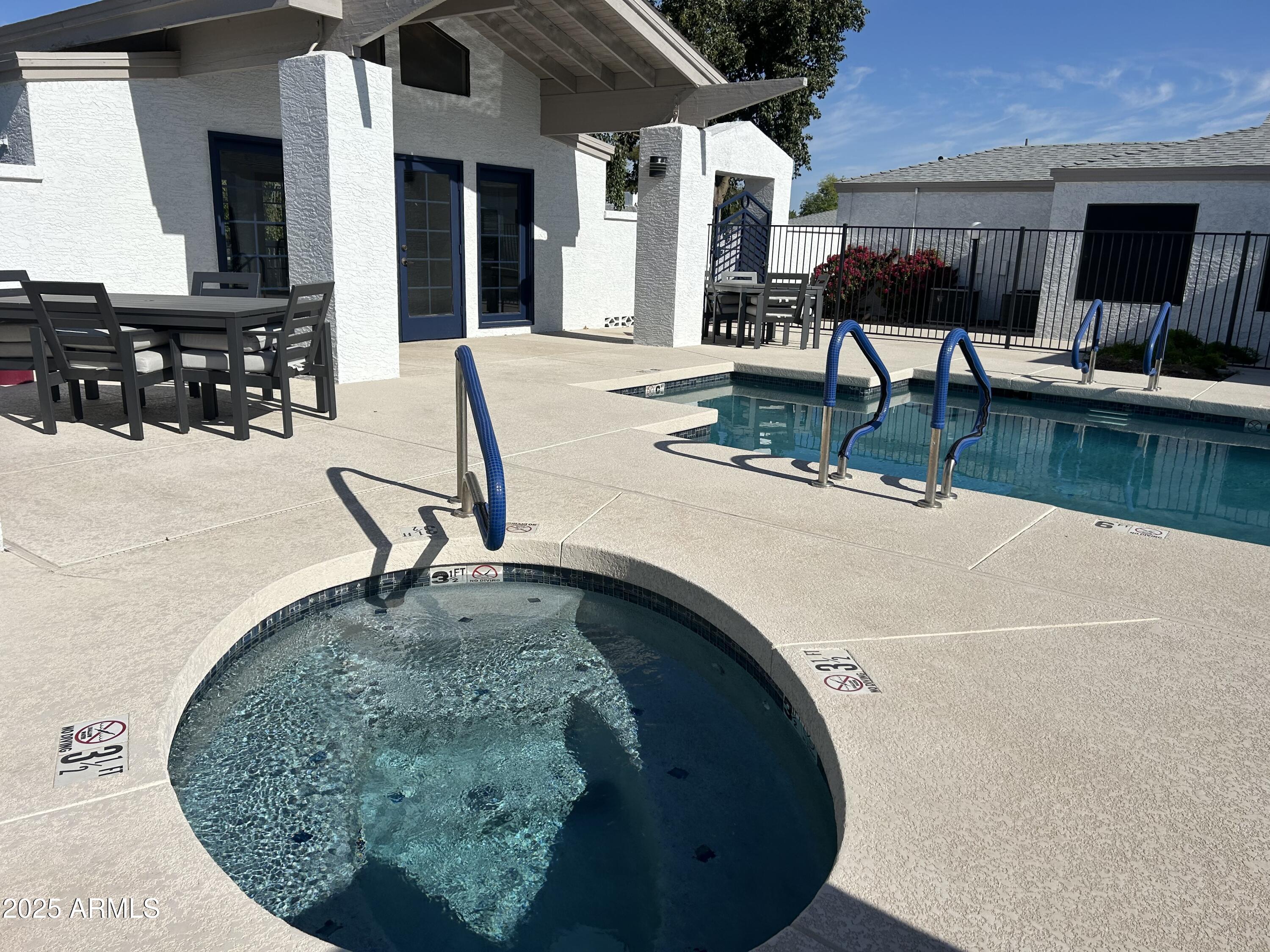 1444 North Recker Road, Unit 163 Mesa, AZ 85205 - Photo 17 of 19 an ocean view with a outdoor seating