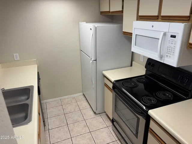 a kitchen with a stove and a refrigerator