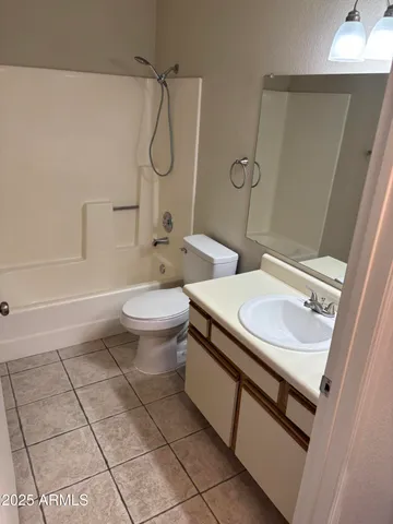 a bathroom with a granite countertop sink a toilet and a mirror