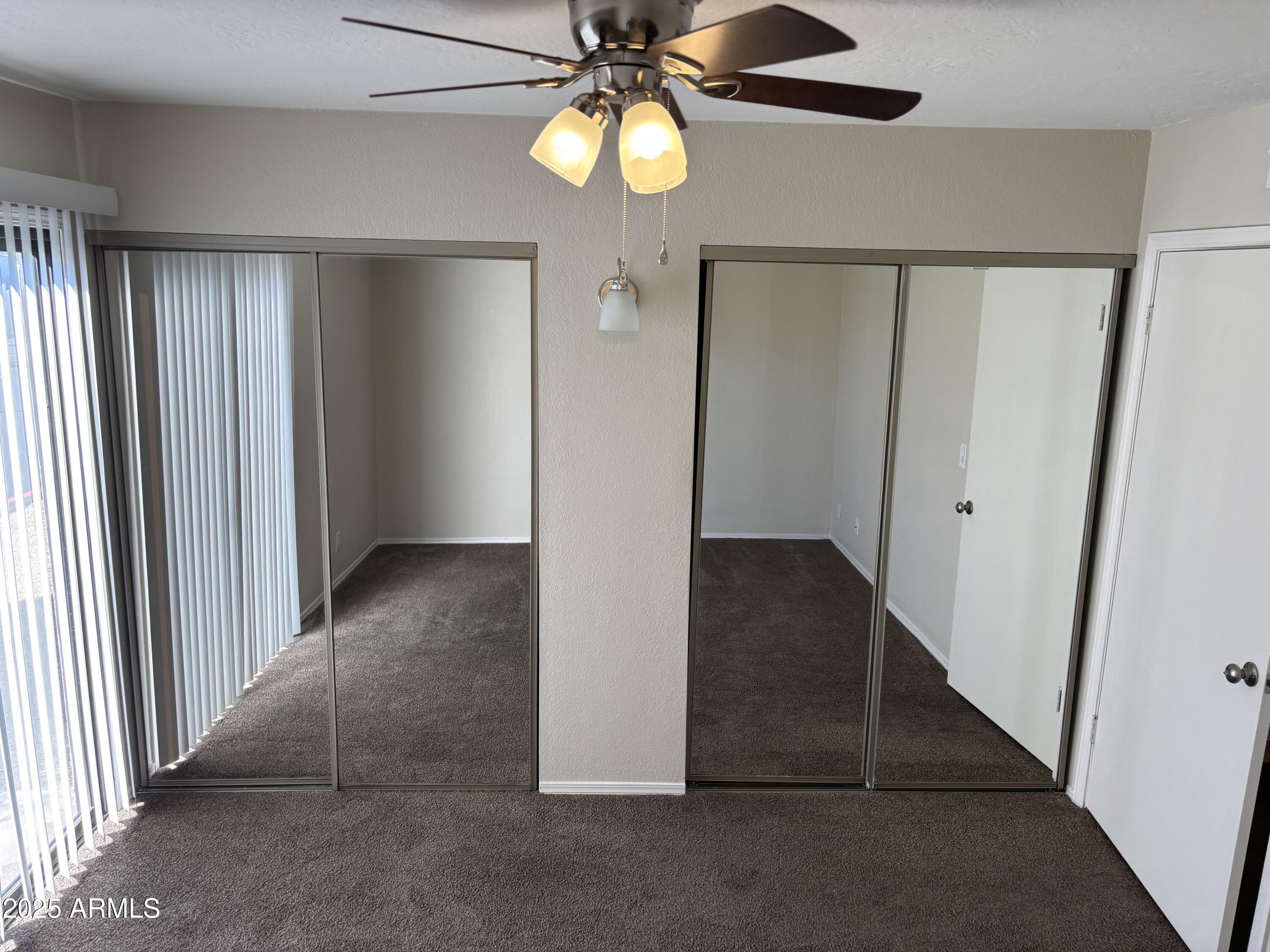 1444 North Recker Road, Unit 163 Mesa, AZ 85205 - Photo 7 of 19 wooden floor in an empty room with a window