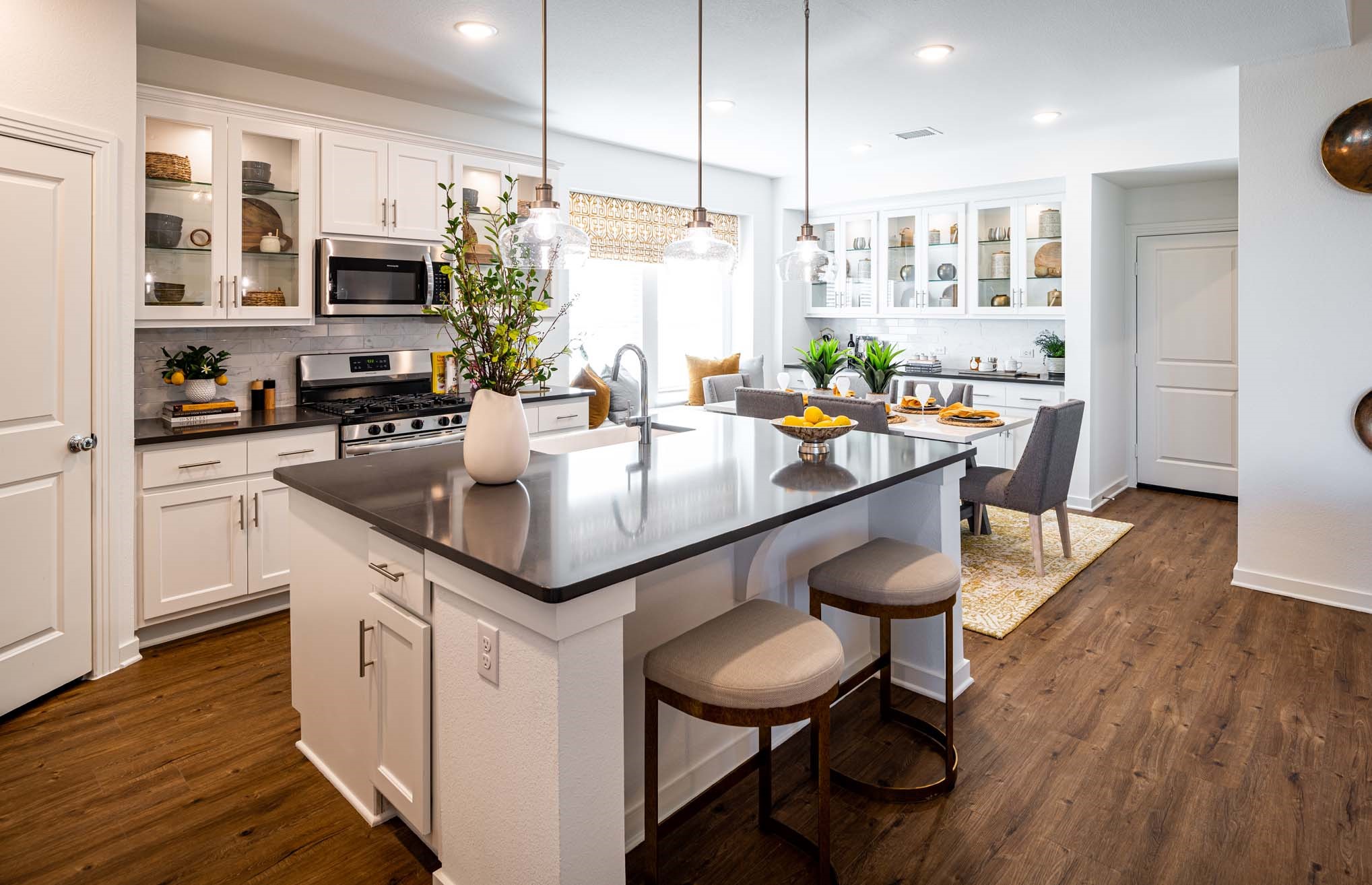 5314 Getty Lane Manvel, TX 77578 - Photo 12 of 17 a kitchen with stainless steel appliances granite countertop a stove refrigerator and a dining table with wooden floor
