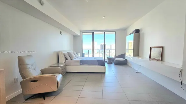 a bedroom with a bed and glass window