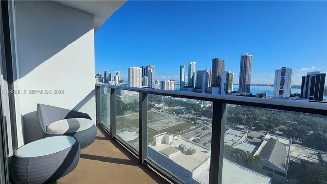 a view of a balcony with furniture and city view