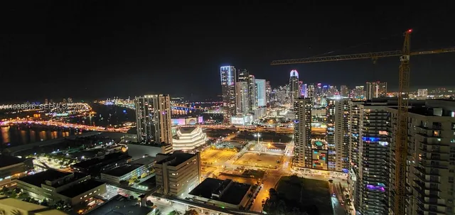 a kitchen with stainless steel appliances kitchen island granite countertop a table chairs sink and cabinets