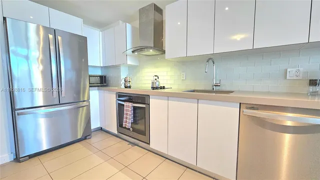 a living room with furniture and a dining table with kitchen view