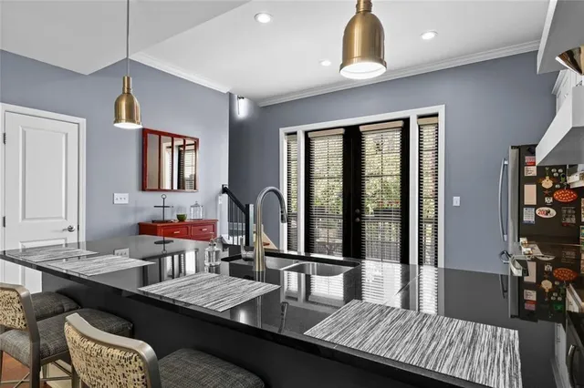 a kitchen with stainless steel appliances granite countertop a stove a sink and a microwave