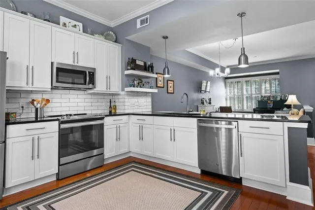 a kitchen with a refrigerator and a sink