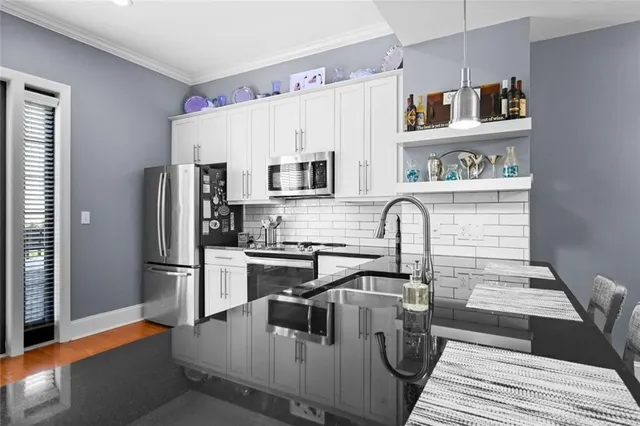a kitchen with a sink stove and cabinets
