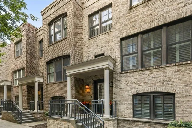 a front view of a house with outdoor seating