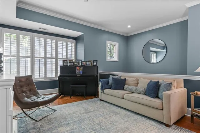 a dining room with stainless steel appliances granite countertop furniture wooden floor and a kitchen view