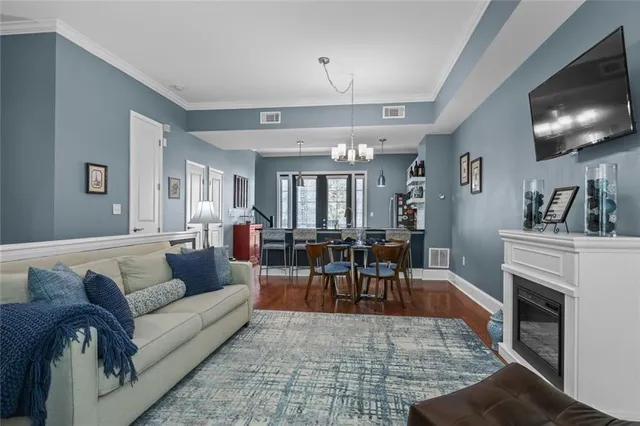 a dining room with furniture and wooden floor