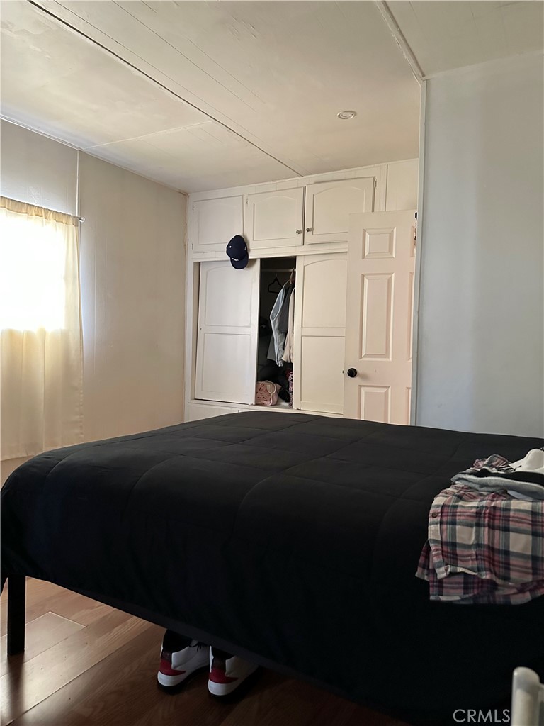 5800 Hamner Avenue, Unit 53 Eastvale, CA 91752 - Photo 13 of 19 a bedroom with a bed and a window