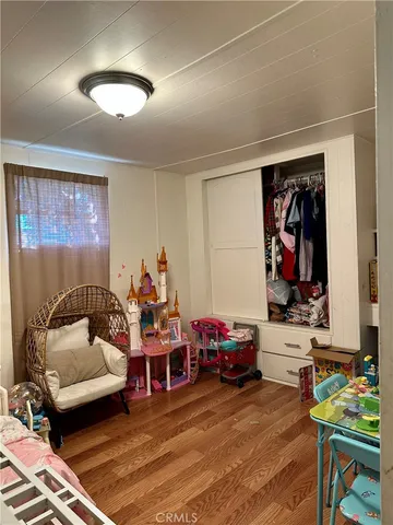 a living room with furniture a air conditioner vent and a window