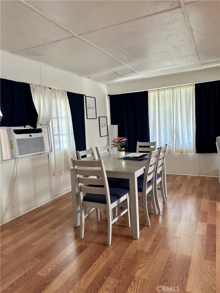 5800 Hamner Avenue, Unit 53 Eastvale, CA 91752 - Photo 4 of 19 a dining room with furniture window and wooden floor