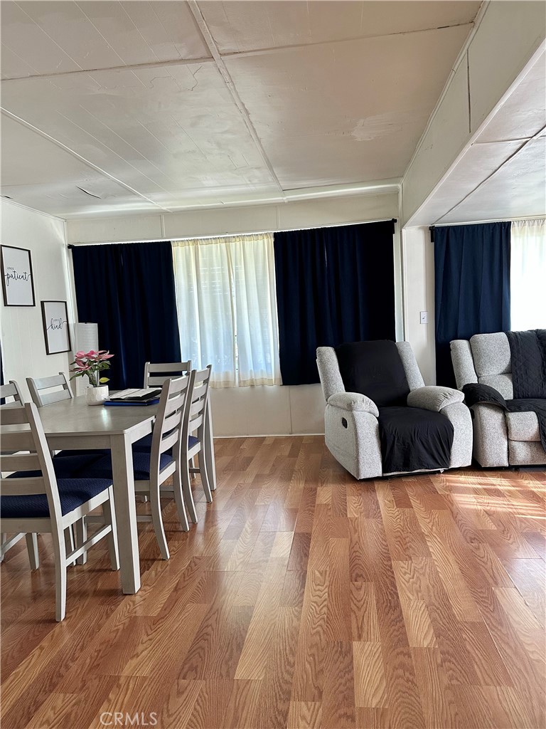 5800 Hamner Avenue, Unit 53 Eastvale, CA 91752 - Photo 5 of 19 a living room with furniture a wooden floor and a flat screen tv