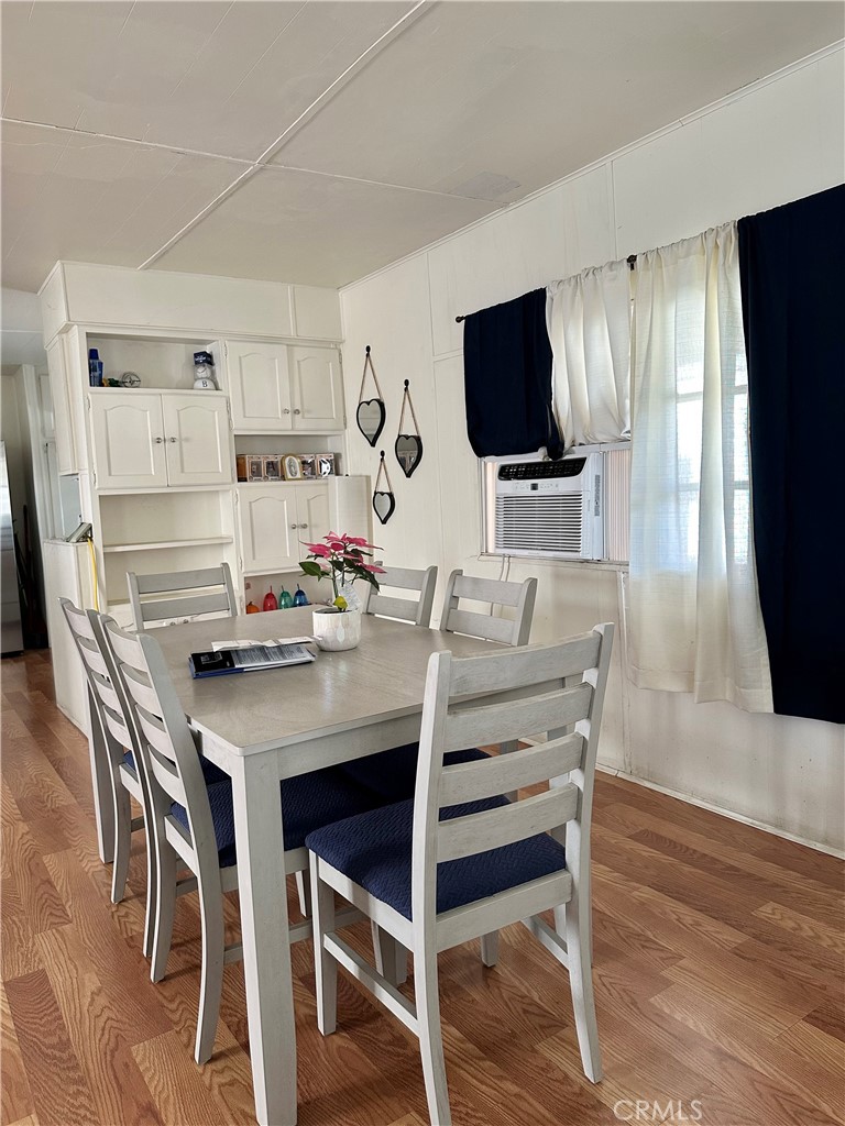 5800 Hamner Avenue, Unit 53 Eastvale, CA 91752 - Photo 6 of 19 a view of a dining room with furniture wooden floor and a flat screen tv