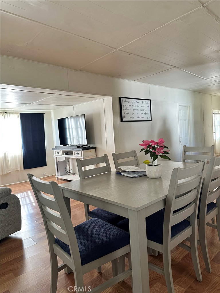 5800 Hamner Avenue, Unit 53 Eastvale, CA 91752 - Photo 7 of 19 a view of a dining room with furniture and wooden floor