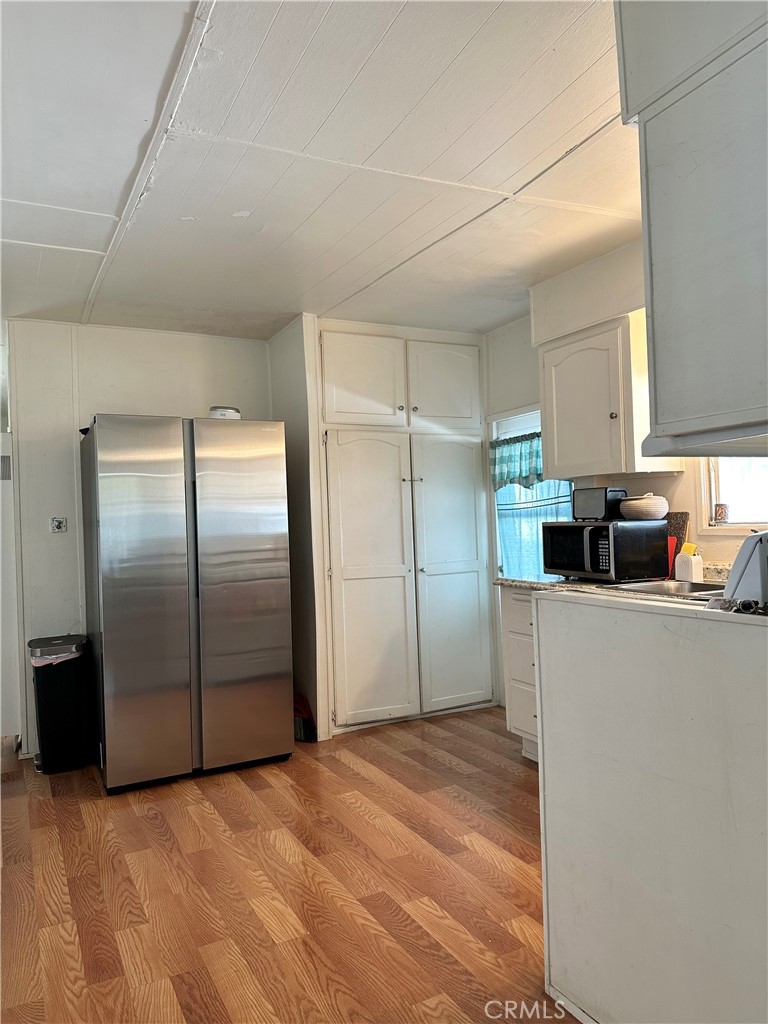 5800 Hamner Avenue, Unit 53 Eastvale, CA 91752 - Photo 8 of 19 a kitchen with stainless steel appliances a refrigerator and a refrigerator
