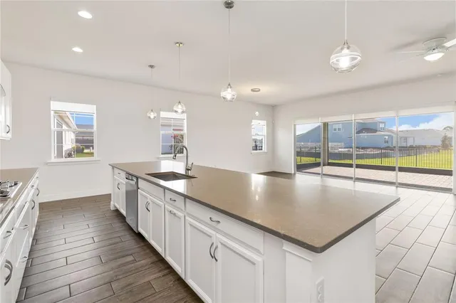 a large kitchen with kitchen island a large counter space a sink and appliances