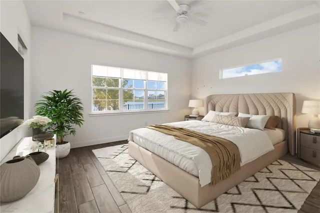 a bedroom with a large bed and a potted plant