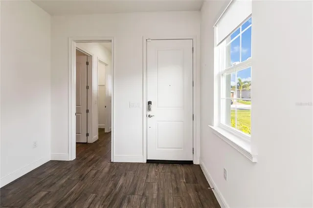 a view of an entryway with wooden floor
