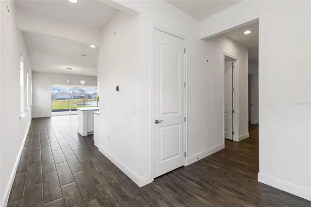 a view of a hallway with wooden floor