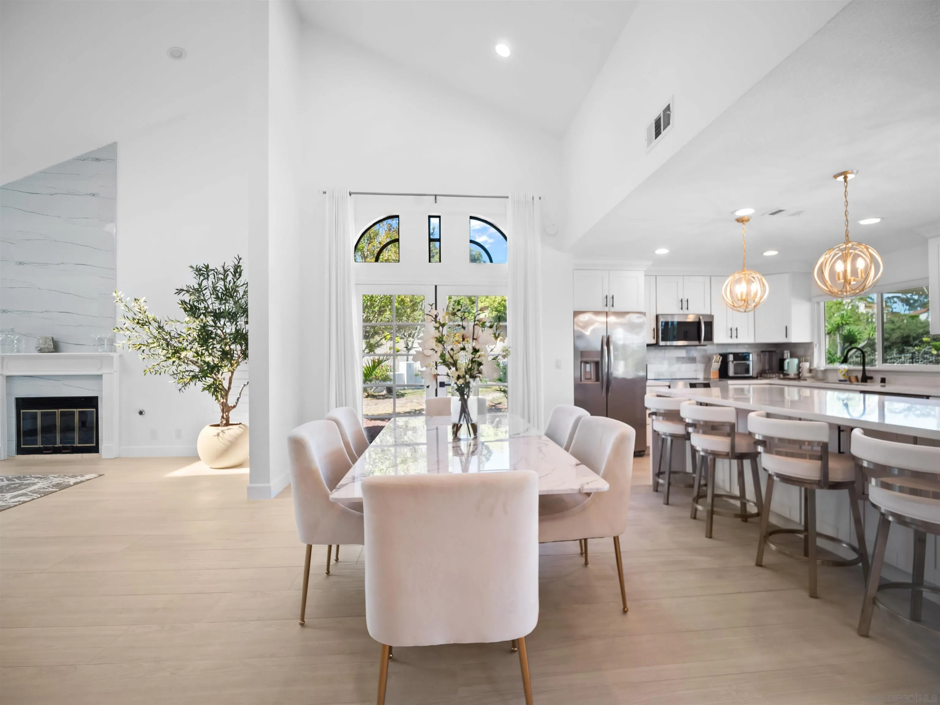 a view of a dining room with furniture and chandelier
