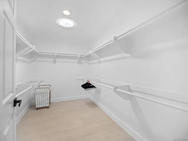 a patio with a table and chairs and potted plants