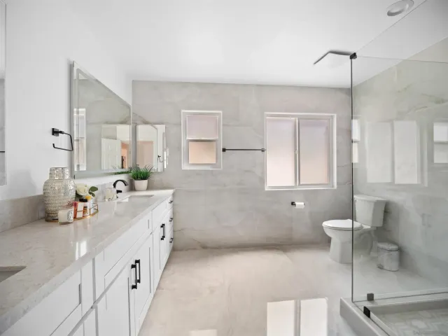 a spacious bedroom with a bed and a lamp