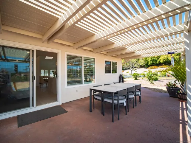 a living room with furniture a fireplace and a potted plant