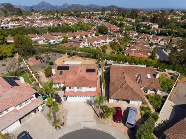 an aerial view of residential houses with outdoor space
