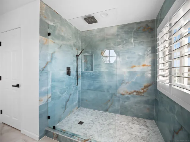 a bedroom with a bed and large window