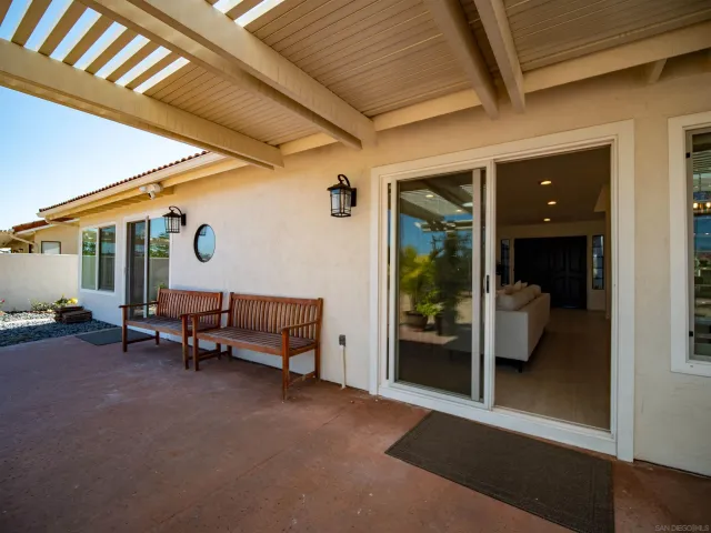 wooden floor with a chandelier and a table