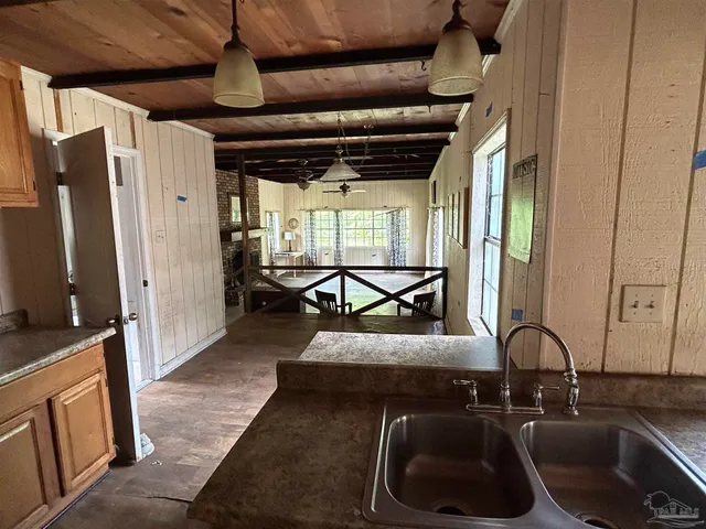 a kitchen with stainless steel appliances granite countertop a sink and a refrigerator