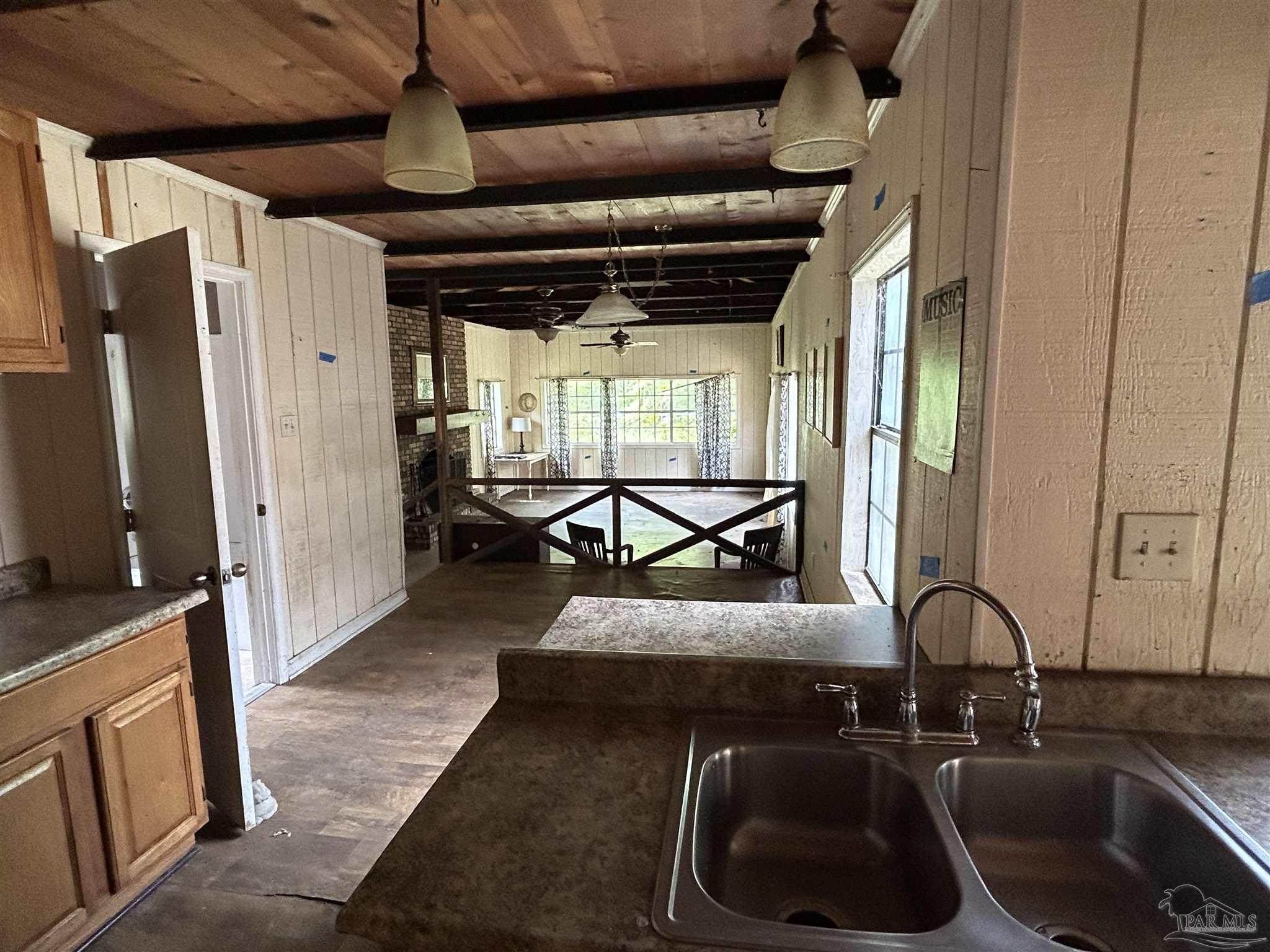 9880 N Loop Pensacola, FL 32507 - Photo 11 of 13 a kitchen with stainless steel appliances granite countertop a sink and a refrigerator