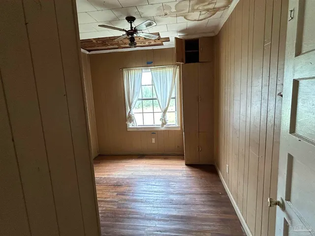 a view of a livingroom with wooden floor and a window