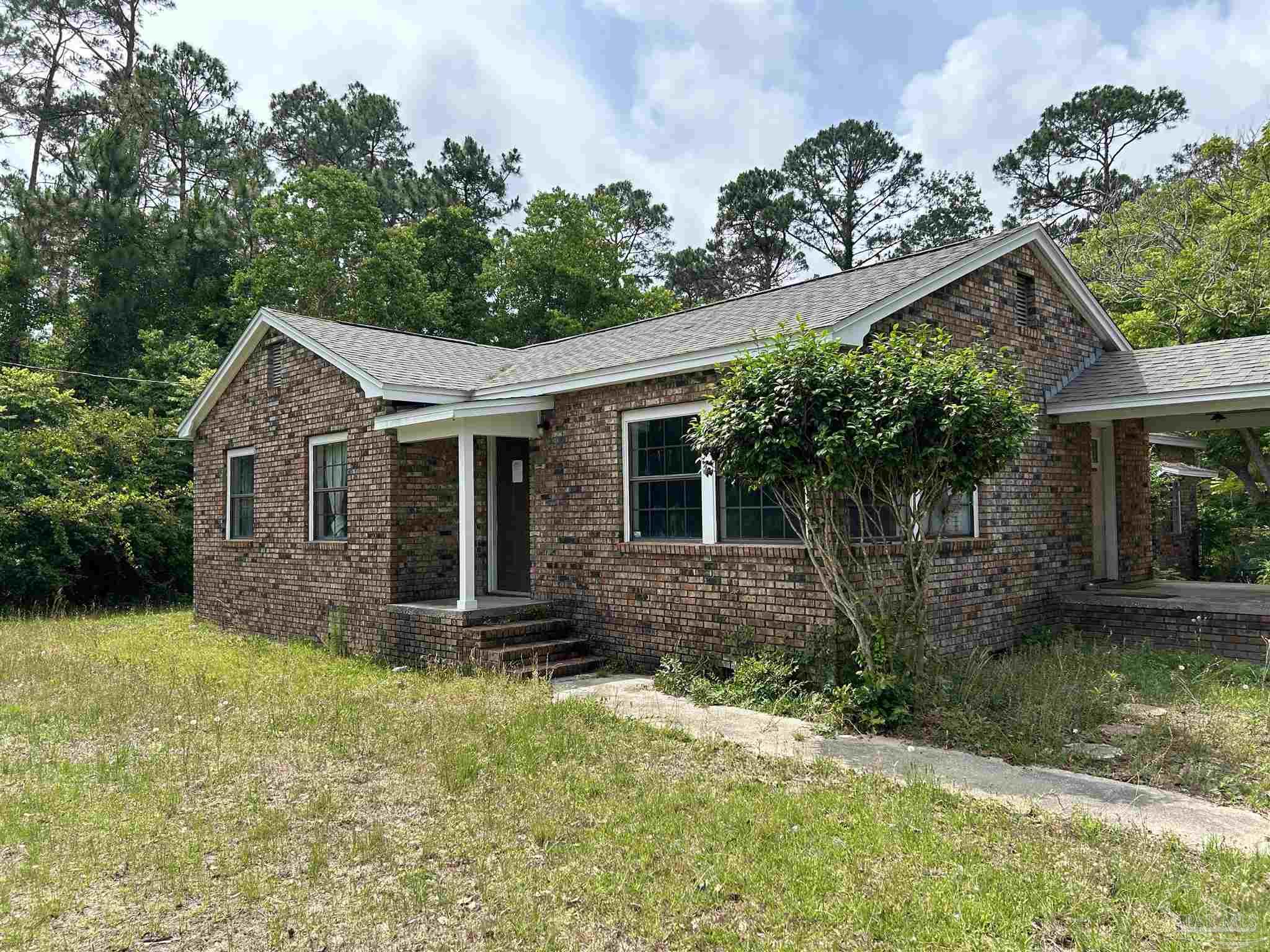 9880 N Loop Pensacola, FL 32507 - Photo 2 of 13 front view of a house with a yard