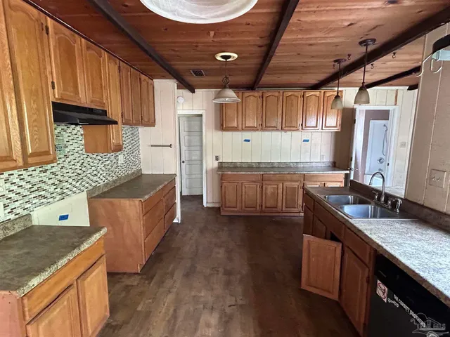 a kitchen with stainless steel appliances granite countertop a sink stove and cabinets