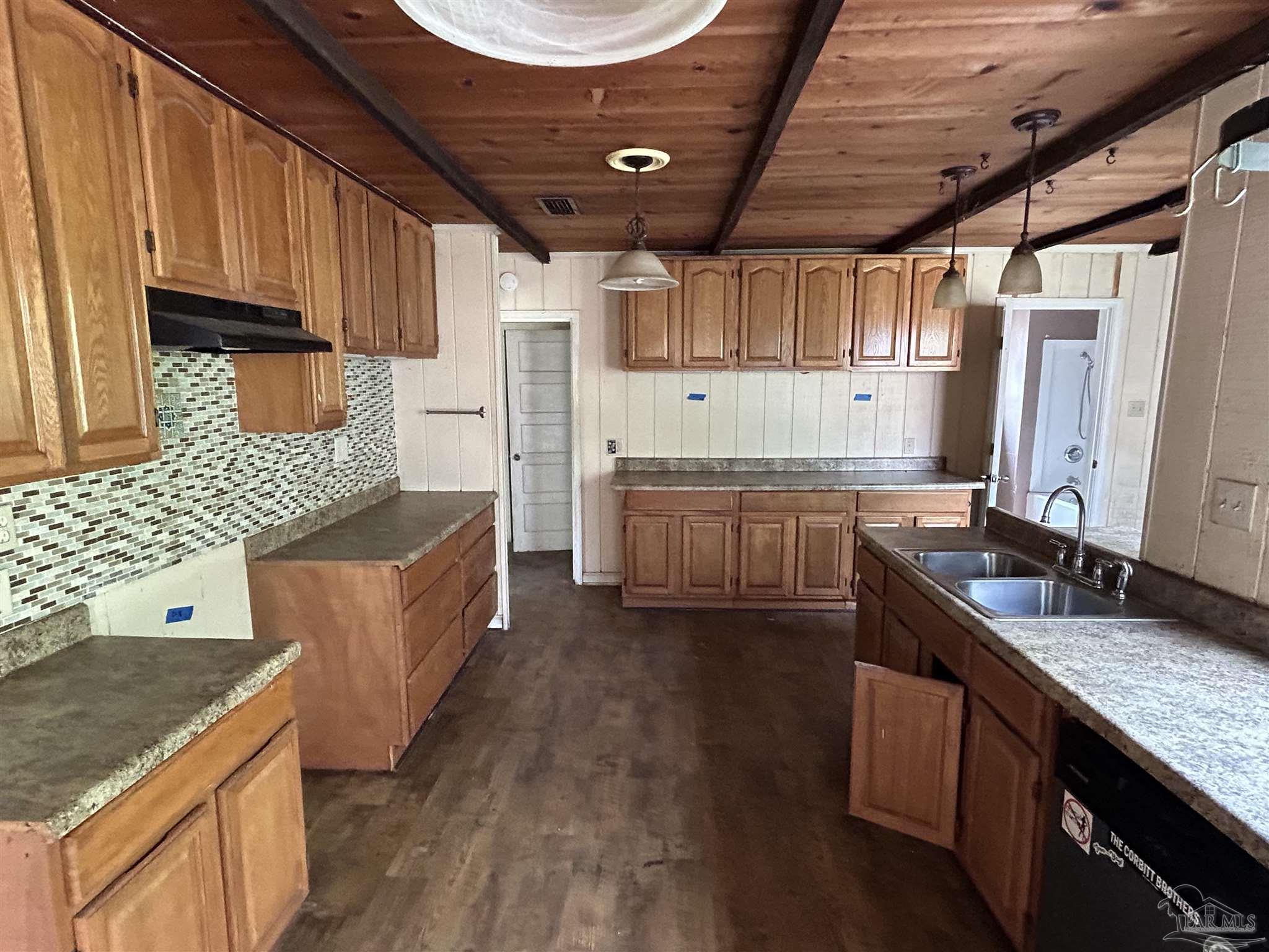 9880 N Loop Pensacola, FL 32507 - Photo 4 of 13 a kitchen with stainless steel appliances granite countertop a sink stove and cabinets