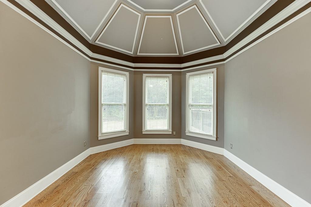 940 Chateau Forest Road Hoschton, GA 30548 - Photo 35 of 87 an empty room with wooden floor and windows