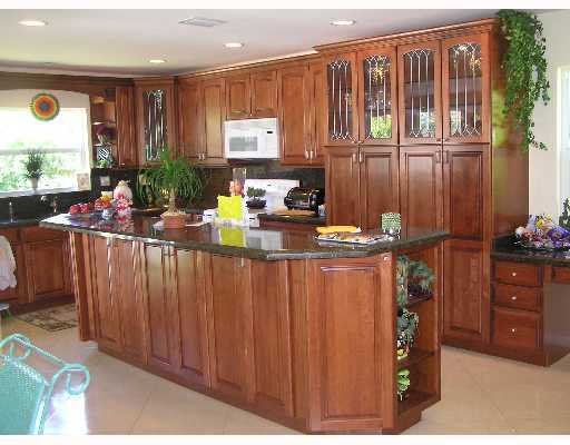 3573 Northwest 4th Avenue Boca Raton, FL 33431 - Photo 9 of 16 a kitchen with a refrigerator and a stove