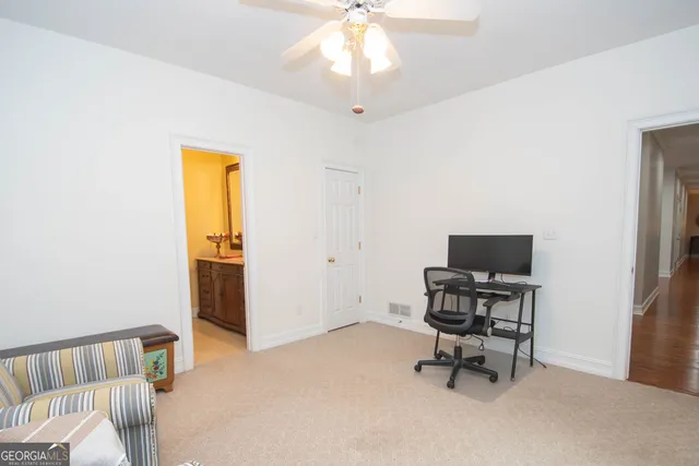 a bathroom with a sink mirror and toilet