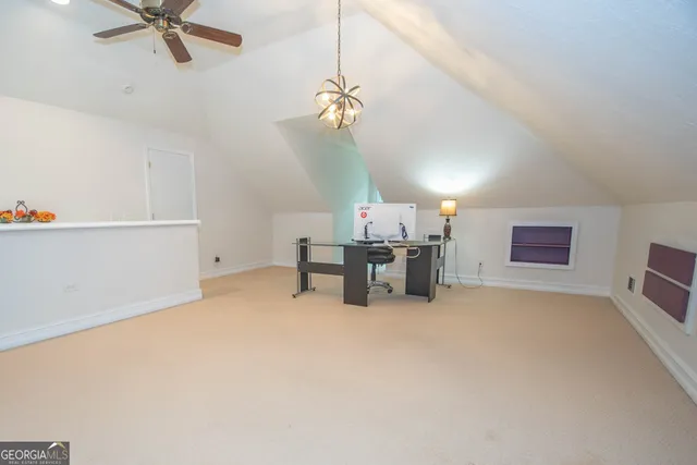 a view of a patio with table and chairs potted plants