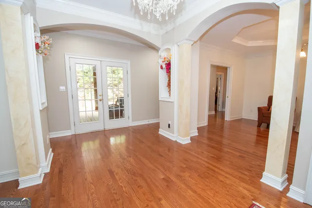 a living room with furniture and a chandelier