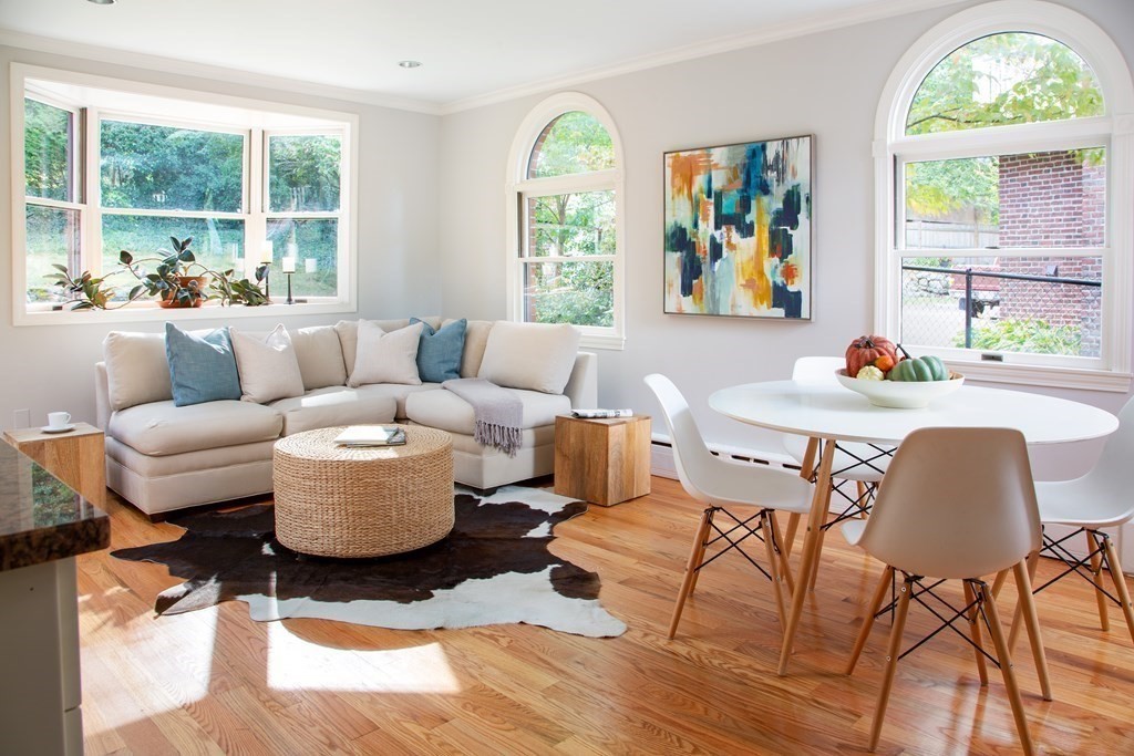 122 Clark Road Brookline, MA 02445 - Photo 2 of 40 a living room with furniture a fireplace and a large window