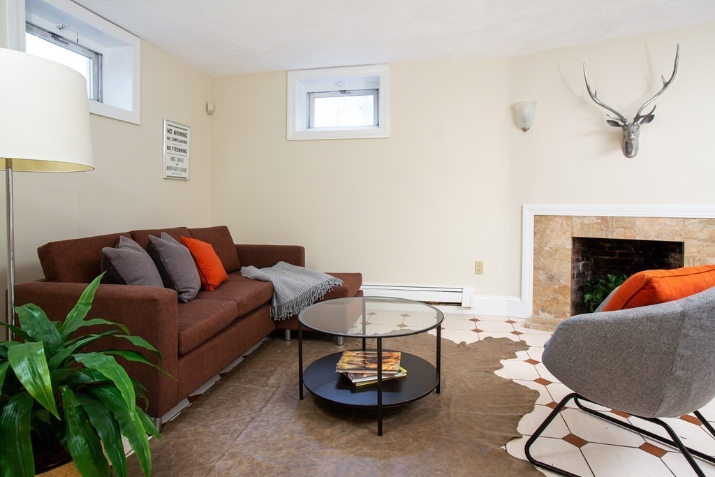 122 Clark Road Brookline, MA 02445 - Photo 32 of 40 a living room with furniture a rug and a fireplace