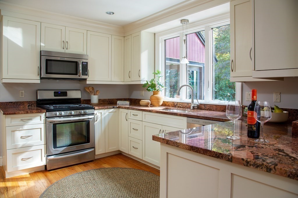 122 Clark Road Brookline, MA 02445 - Photo 7 of 40 a kitchen with stainless steel appliances a stove a sink and a microwave